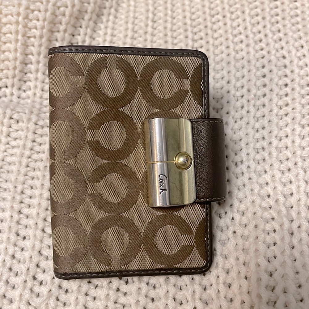 Dark brown and light brown Coach fold wallet